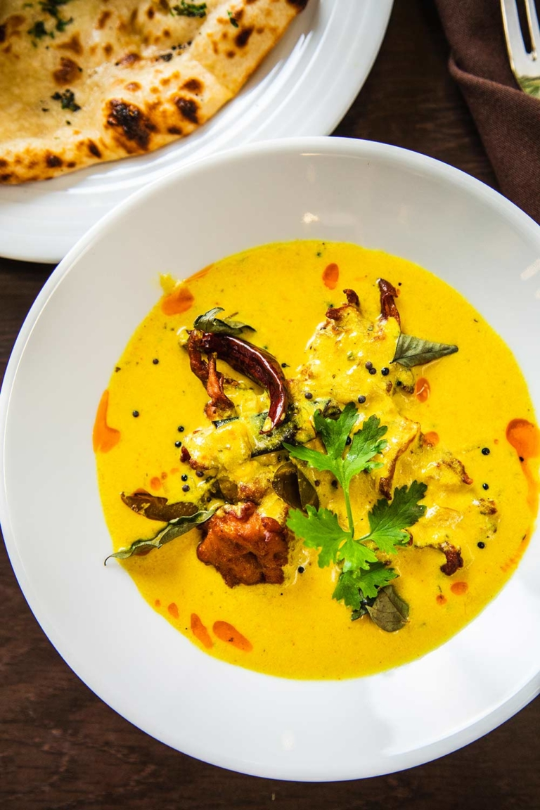 Punjabi kadhi pakora with curry leaves and coriander